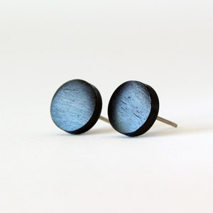 May include: A pair of round wooden earrings with a black and blue gradient finish.