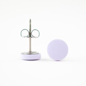 May include: A pair of lavender colored stud earrings with silver posts and butterfly backs.