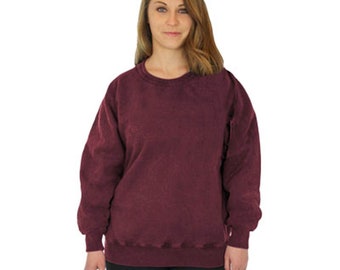 May include: A maroon crew neck sweatshirt with ribbed cuffs and hem. The long-sleeved top is a solid color and is worn by a person. The person is wearing black pants.