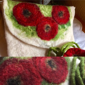 May include: A white felt bag with a flap closure and a drawstring. The bag is decorated with three red felt poppies with black centers. The bag has a green felt trim.