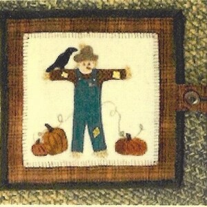 May include: Three framed felt pictures with a fall theme. The center picture shows a wagon full of pumpkins. The pictures on either side show scarecrows with crows.