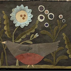 May include: A handcrafted textile art piece featuring a bird amidst stylized flowers and foliage. The bird has a red breast and gray body. The flowers are light blue, orange, and white, set against a dark gray background. The piece is likely made of felt.