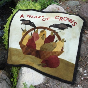May include: A white felt wall hanging with the text "A 'PEAR' OF CROWS" in red lettering. The design features two black crows, a basket of pears, and a brown felt background.