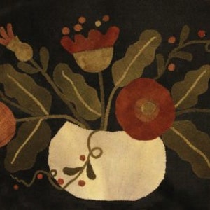 May include: A vintage-style needlepoint wall hanging featuring a bouquet of red and orange flowers in a cream-colored vase. The flowers are surrounded by green leaves and vines on a dark background.