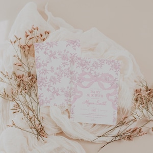 May include: Baby shower invitation with a pink floral and ribbon design. The invitation includes the text "Baby Shower" and the name "Alyssa Smith". The invitation is on a white background with pink floral accents.