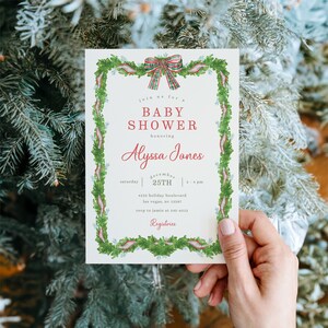 May include: A baby shower invitation with a green and red floral border and a plaid bow at the top. The invitation text reads "Baby Shower honoring Alyssa Jones" with the date December 25th and the time 2-4 pm.