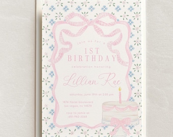 May include: A pink and blue floral patterned invitation for a 1st birthday party. The invitation features a pink gingham bow and a cake with a single candle. The text reads "Join us for a 1st Birthday celebration honoring Lillian Rae, Saturday, June 19th at 2:00 pm, 1874 Floral Boulevard, Las Vegas, NV 14578, RSVP to Jamie at 851-982-3268."