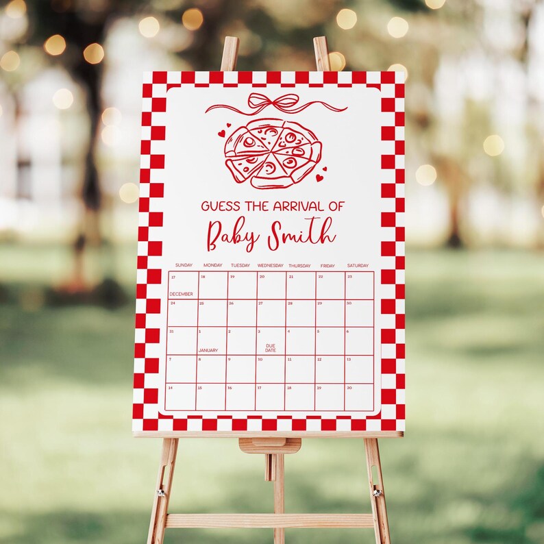 May include: A white sign with a red checkered border and a calendar grid. The sign reads "Guess the Arrival of Baby Smith" with a pizza graphic. The sign is displayed on a wooden easel.