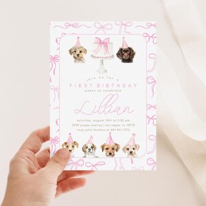 May include: Pink and white first birthday party invitation with a watercolor illustration of dogs wearing party hats and a cake. The invitation includes the text "Join us for a First Birthday party to celebrate Lillian" and the date, time, address, and RSVP information.