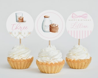 May include: Three cupcake toppers with a milk and cookies theme. The toppers feature a glass of milk and cookies, a milk jug and cookies, and a pink bow with the text "Happy Birthday Lillian".