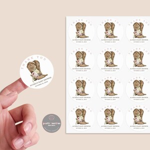 May include: A sheet of 12 round thank you stickers with a watercolor illustration of brown cowboy boots with pink flowers. The text on the stickers reads "Thank You Alysa's Baby Shower October 21, 2023".
