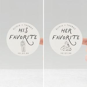 May include: Two round stickers with the text "Olivia + Thomas" and "His Favorite" and "Her Favorite" in black script. The "His Favorite" sticker has a tuxedo illustration, and the "Her Favorite" sticker has a cake illustration. The date "10.01.XX" is printed at the bottom.
