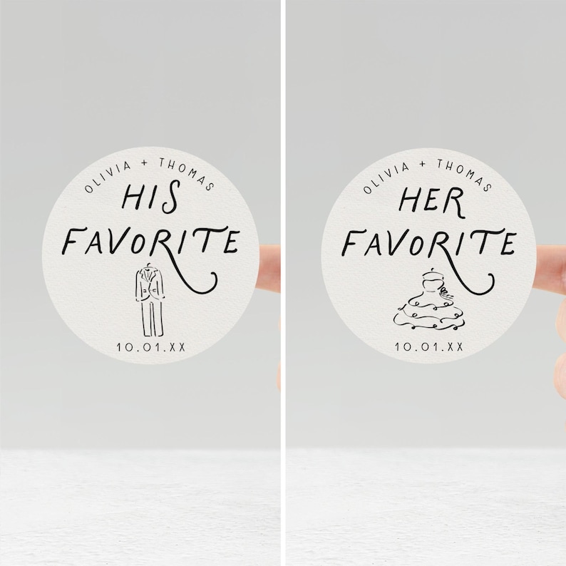 May include: Two round stickers with the text "Olivia + Thomas" and "His Favorite" and "Her Favorite" in black script. The "His Favorite" sticker has a tuxedo illustration, and the "Her Favorite" sticker has a cake illustration. The date "10.01.XX" is printed at the bottom.
