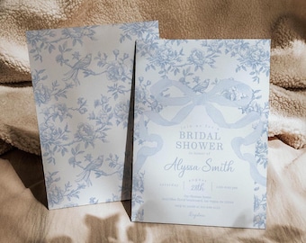 May include: A blue and white floral patterned bridal shower invitation with a blue ribbon bow and the text "Join us for a Bridal Shower in honor of Alyssa Smith, Saturday, November 28th, 2:00-4:00 pm, The Farmhouse, 123 Main Street, Anytown, 12345. RSVP by November 15th.  We can't wait to celebrate with you!"