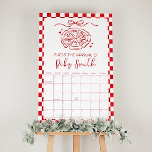 May include: A white calendar with a red checkered border and a pizza graphic. The text "GUESS THE ARRIVAL OF Baby Smith" is written in red. The calendar grid is for December and January.