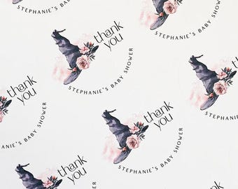 May include: Thank you stickers with a black witch hat and pink flowers. The text "Stephanie's Baby Shower" is repeated on each sticker.