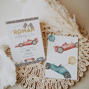 May include: A birthday invitation for a boy named Roman turning one year old. The invitation features a red race car with checkered flags and the text "Roman is turning one".