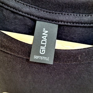 May include: A black Gildan Softstyle t-shirt with the word "SKY" printed in white on the front.