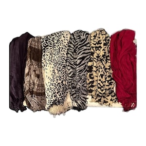 May include: Seven different patterned scarves, including a black and white zebra print, a leopard print, a red scarf, and a brown and white scarf.
