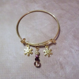 Goldtone Snowflake Charm Bracelet with Purple Bead Dangle image 1
