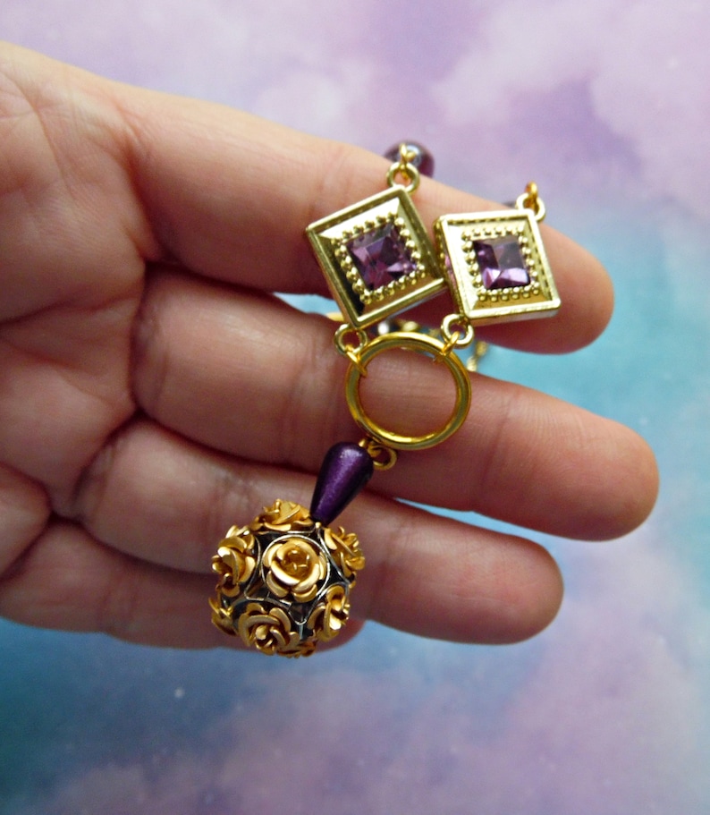 Purple and Goldtone Diamond Shaped Necklace with Rose Ball Bead