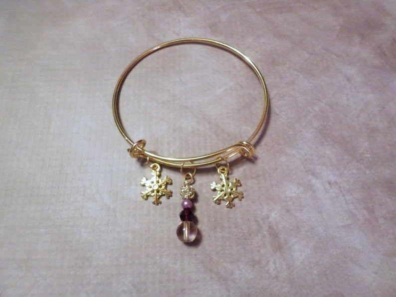 Goldtone Snowflake Charm Bracelet with Purple Bead Dangle image 1