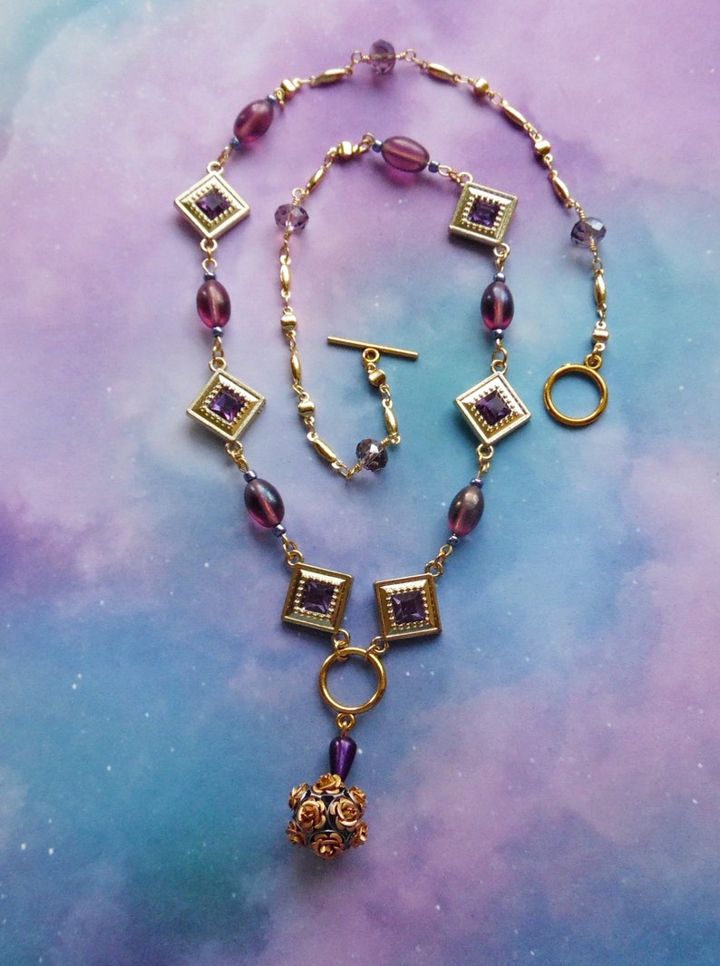 Purple and Goldtone Diamond Shaped Necklace with Rose Ball Bead
