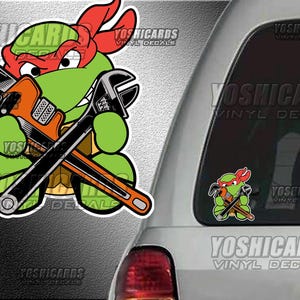 May include: A green cartoon turtle wearing a red bandana and holding two crossed wrenches. The turtle is smiling and has a mischievous look on its face. The wrenches are crossed in front of the turtle's chest. The background is a gray and white textured surface.