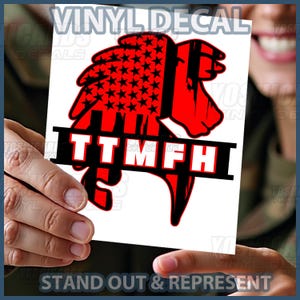 May include: A red and black vinyl decal featuring a lion's head design with an American flag pattern. The text "TTMFH" is displayed in white letters on a black banner. The words "STAND OUT & REPRESENT" are at the bottom.