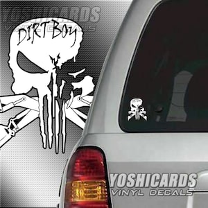 May include: White vinyl decal of a skull with crossed shovels and the text "Dirt Boy" on the top. The decal is on the back window of a silver SUV. The text "YoshiCards Vinyl Decals" is on the lower right corner of the image.