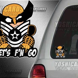 May include: A black and yellow vinyl decal featuring a stylized Wolverine character with a military insignia and the text "LET'S F'N GO". The decal is applied to a car window, with the brand name "YOSHICARDS VINYL DECALS" visible.