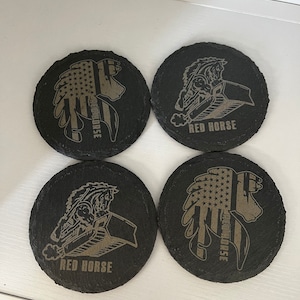 May include: Four round black slate coasters. Two coasters feature a horse head design with an American flag pattern and the text "RED HORSE". The other two coasters have a horse and tractor design with the text "RED HORSE".
