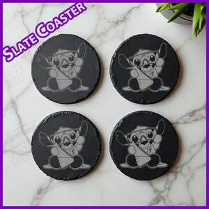 May include: Four round black slate coasters. Each coaster features a gray cartoon character holding a beaker. The text "Slate Coaster" is in the upper left corner. The coasters are on a white marble surface.