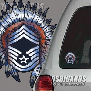 May include: A vinyl decal featuring a stylized Air Force Chief Master Sergeant rank insignia, integrated with a Native American headdress design. The design incorporates blue, white, red, and silver colors. The decal is shown on a car window.