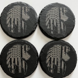 May include: Four black slate coasters with a design featuring an American flag incorporated into a horse head silhouette. The text "REDHORSE" is vertically aligned on the right side of the horse head.