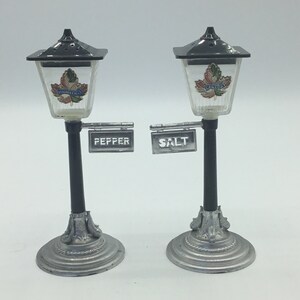 VTG BRASS AND GLASS STREET LIGHT LAMP POST SALT AND PEPPER SHAKER SET LID  OPENS. Missing the stands but they do still stand up. They have some tarnis  for Sale in Halndle