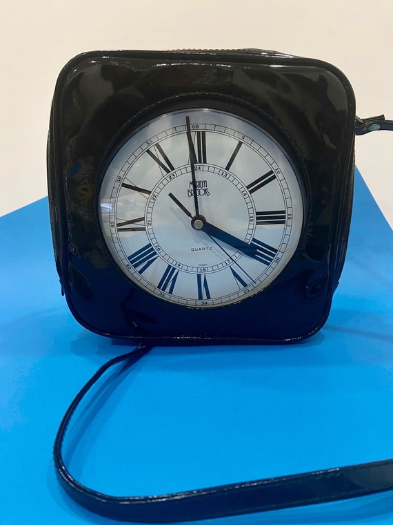 Premium Photo | Alarm clock and school bag and book on a table