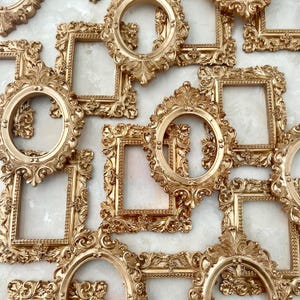 May include: A collection of ornate gold picture frames with intricate details and various sizes. The frames are arranged in a random pattern, creating a visually appealing and decorative display.