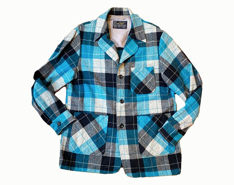 May include: A blue, black, and white plaid jacket with a button-up front and two pockets.