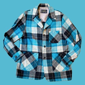 May include: A blue, black, and white plaid jacket with two pockets and a button closure.