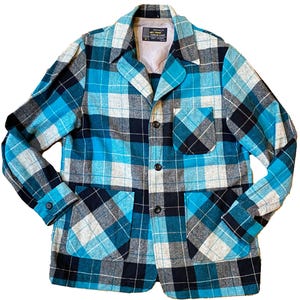 May include: A blue, black, and white plaid jacket with a button-up front and two patch pockets. The jacket has a label that reads "Penman's "Sherwood"  Casual Coat".