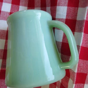 Vintage raised  bottom Fire King Oven Ware Jadeite D handle mug is stamped on bottom coffee/shaving mug- no chips or cracks- Old mark!