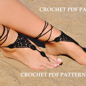 May include: Black crochet barefoot sandals with a delicate floral design, tied with thin black cords. The sandals are displayed on a sandy surface. Text on the image reads "CROCHET PDF PATTERN".