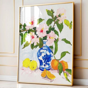 May include: A painting of a blue and white porcelain vase filled with pink flowers and lemons. The vase is decorated with a floral pattern and sits on a white table with a pink tablecloth.