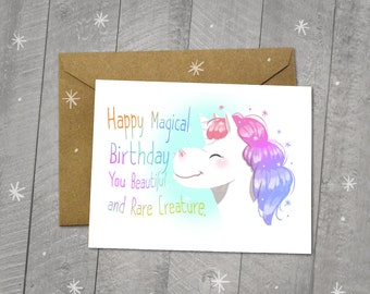 May include: A blank greeting card with a colorful illustration of a unicorn with the text "Happy Magical Birthday You Beautiful and Rare Creature."
