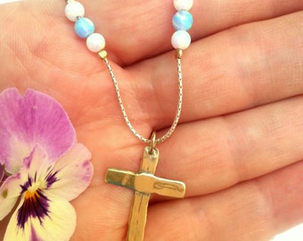 Gold Cross on a silver chain with blue and white Opal beads