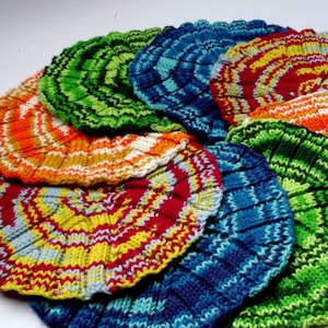 May include: A collection of colorful knitted dishcloths in a variety of patterns, including stripes, swirls, and zigzags.