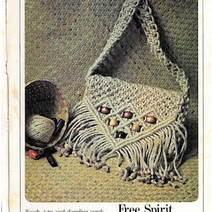 May include: A beige macrame bag with fringe and wooden beads. The bag is on a woven surface. "Free Spirit" is written in the image.