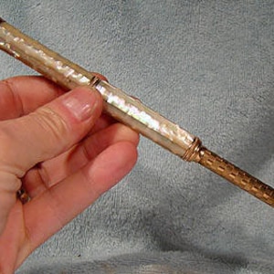 May include: A vintage gold and mother-of-pearl pencil with a decorative top.