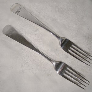 May include: Two silver forks with the inscription "W.R.R." on the handle.